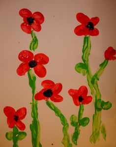 some red flowers are painted on a white board with green stems and black dots in the middle