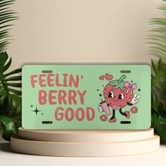 a sign that says feelin'berry good on the side of a table next to some plants