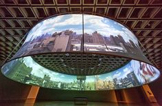 the ceiling is covered with large images of city buildings and skyscrapers on it's sides