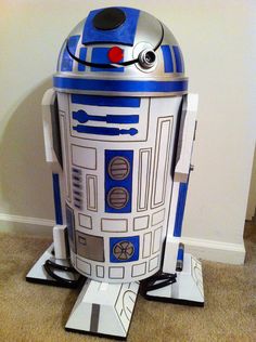 a star wars r2d2 cardboard cutout sitting on the floor