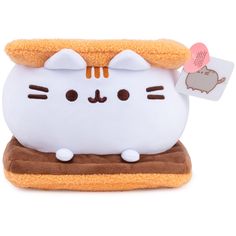 a white cat with brown ears and tail on top of a piece of bread that is shaped like a toaster