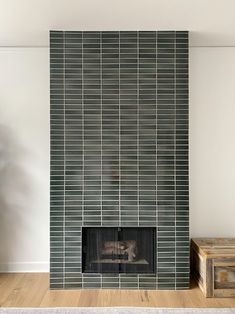 a living room with a fireplace and tiled walls in it's centerpieces