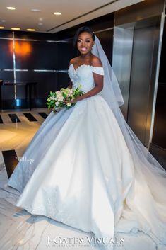 a woman in a wedding dress posing for the camera