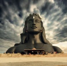 a large statue sitting under a cloudy sky