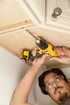 a man holding a drill in his right hand