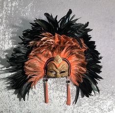 This masquerade mask belongs to our collection of feathers' masks. These masks have a crown of black and colored feathers. It is perfect for any masquerade party, Halloween costume, pro or event in Venice or elsewhere during Carnival. This mask can be gently bent to form to your face and ties in the back with two soft matching ribbons.It is decorated with macrame lace,gold leaf and swarovski. Size: one-size This kind of mask is also perfect as in interior design element, wall decoration. Each ma Black Masks And Prosthetics For Mardi Gras, Feather Masks For Carnival Costume Party, Feathered Masks For Carnival Costume Party, Feathered Masks For Masquerade Carnival, Carnival Masquerade Masks And Prosthetics With Feathers, Feathered Masquerade Mask For Mardi Gras, Feathered Masks And Prosthetics For Carnival Masquerade, Carnival Masquerade Masks With Feathers, Carnival Feather Eye Mask