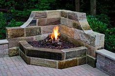 a fire pit sitting on top of a brick patio