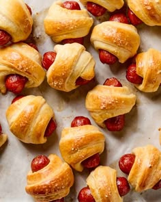 croissants with strawberries are on a baking sheet