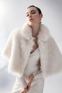 Dress the party: receive 20% off when purchasing four or more bridal styles. Use code BRIDAL20 at checkout. Luxurious and chic, this gorgeous cape is made from the most premium faux fur and features a wide collar with a concealed hook & eye closure in the front. Perfect for a black-tie event or regular wear, this cozy cape is the perfect layering piece for a girl with ethical fashion in mind. This garment is a one-size-fits-all. Bridal Styles, Elegant Drapes, Black Tie Event, Hook Eye, Ethical Fashion, Layering Pieces, Black Tie, Bridal Style, A Girl