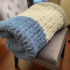 two blankets are sitting on top of a chair