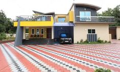 a car parked in front of a multi - colored house on a checkered floor