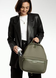 Crafted from our high-quality nylon and designed with ample storage space, the Eli backpack boasts a modern, minimalist design that complements various styles. A dedicated compartment for a 13" laptop, multiple pockets, and organizational features make it ideal for both work and play. Whether you're heading to the office, school, or a weekend adventure with your littles, Eli is the perfect companion. Common Uses: Diaper Bag, Work Bag, Travel Bag Insulated Siding, Unicorn Bag, Stroller Hooks, Backpack Reviews, Modern Minimalist Design, Monogrammed Items, Backpack Straps, Work Bag, Changing Pad