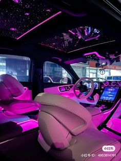 the interior of a car with purple lighting