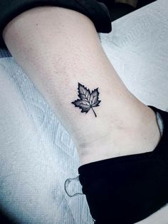 a small leaf tattoo on the ankle