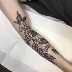 a person with a flower tattoo on their arm