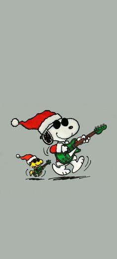 snoopy playing guitar while wearing a santa hat and green pants with his feet in the air