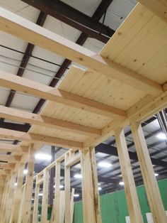 the inside of a building with wooden beams in place to support the roof rafters