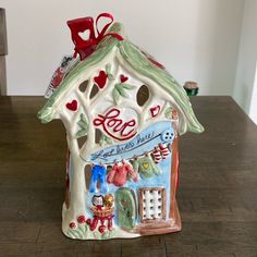 a ceramic house with hearts on the roof