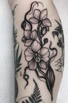 a black and white flower tattoo on the leg