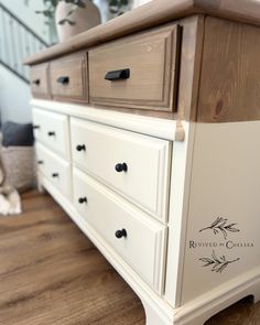 a white dresser sitting on top of a wooden floor