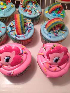 cupcakes decorated with pink frosting and rainbow decorations