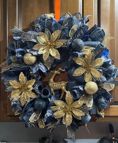 a blue and gold wreath on the front door