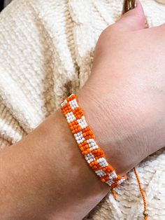 Beaded Orange and White Checkerboard Adjustable Bracelet Orange Seed Bead Bracelet, Summer White Adjustable Friendship Bracelets, Casual Orange Braided Bracelets For Friendship, Casual Orange Braided Bracelet For Friendship, Trendy White Handmade Braided Bracelets, Handmade Orange Casual Friendship Bracelet, Trendy White Handmade Braided Bracelet, Casual Handmade Orange Friendship Bracelets, Casual Handmade Orange Friendship Bracelet