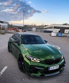 a green sports car parked in a parking lot