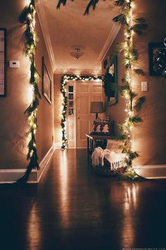 the hallway is decorated for christmas with garlands and lights on it's sides