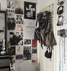 there is a wall with pictures and other items on it in the room, along with earbuds hanging from hooks