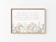 a framed print with the words, and flowers on it in pinks and greens