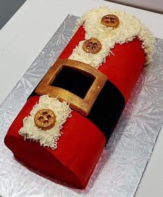 a cake made to look like a red fire hydrant with white and gold decorations