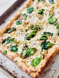 a pizza sitting on top of a pan covered in cheese and vegtables