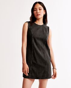 Elevate your wardrobe with the Abercrombie & Fitch Women's Denim Shift Mini Dress, a perfect blend of style and sustainability. This chic black mini dress is designed for the modern woman, featuring a sophisticated high-neck and seamless center-back zipper that ensures a sleek silhouette.

- Size: XS PETITE
- Color: Black
- Material: Cotton, TENCEL™ Lyocell
- Gender: Female
- Age Group: Adult

Crafted from a comfortable denim fabric, the dress boasts on-trend seaming details that enhance its sha Chic Black Dress, Shift Mini Dress, High Neck Designs, Denim Mini Dress, Mini Shift Dress, Black Mini, Denim Fabric, Mini Black Dress, Women's Dresses