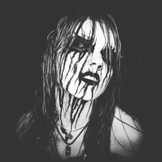 a black and white photo of a woman with blood dripping down her face, in the dark