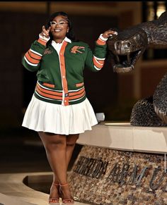 a woman standing in front of a statue