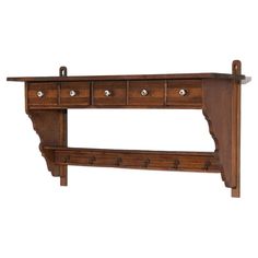 a wooden shelf with four drawers and two hooks on the bottom, one drawer open