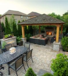 an outdoor living area with patio furniture and fire pit