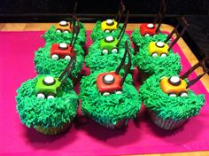 cupcakes decorated with green frosting and colorful decorations