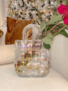 a vase filled with flowers next to a christmas tree