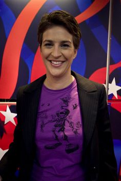 a woman standing in front of a red, white and blue wall with stars on it