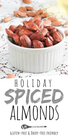 a bowl full of almonds sitting on top of a table with the words holiday spiced almonds