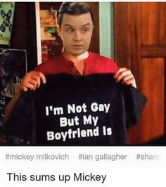 a man holding up a t - shirt that says i'm not gay but my boyfriend is