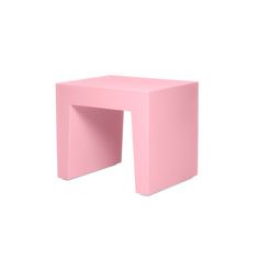 a small pink table with an open end section on the top and one side that has a hole in it