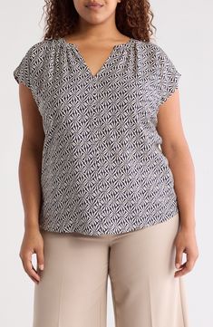 An eye-catching pattern covers this fabulous popover top designed with a notched neckline. 30" length V-neck Cap sleeves 80% rayon, 20% nylon Hand wash, line dry Imported Patterned V-neck Blouse For Work, Patterned V-neck Workwear Blouse, Patterned V-neck Rayon Tops, Patterned Rayon V-neck Top, Printed V-neck Rayon Tops, Casual Patterned Viscose Top, Casual Viscose Top With Split Neck, Printed Viscose V-neck Top, Chic Patterned V-neck Top