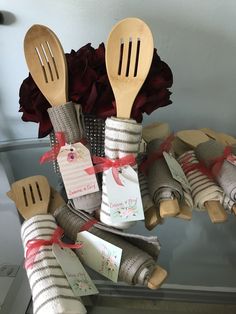 wooden utensils are wrapped in burlap and tied with ribbon for decoration