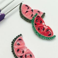 two pieces of paper are being made to look like watermelon slices and spirals