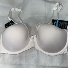 Elevate Your Bra Game With This Stunning Bali Women's One Smooth U Ultra Light Illusion Neckline Underwire Bra. Designed To Provide Maximum Comfort And Support, This Bra Features A T-Shirt Style With An Underwired Neckline That Enhances Your Silhouette. The Bra Is Made With A Smooth And Lightweight Material That Gives You A Comfortable Fit All Day Long. With A Size Of 36d And A White Color, This Bra Is Perfect For Any Occasion. The Bali One Smooth U Product Line Guarantees That You Are Getting A White Bra-friendly Low-cut Top, White Padded Full Cup Bra, Elegant White Underwire Bra, White Padded Underwire Bra, White Padded Push-up Bra, White Seamless Underwire Bra, Compressive Seamless White Bra, White Bra With Built-in Support And Micro-elastic Fit, Bali Bras