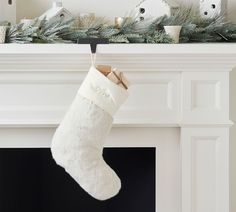 a white christmas stocking hanging from a mantel