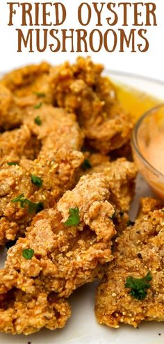 fried oyster mushrooms on a white plate with dipping sauce in the middle and text overlay that reads fried oyster mushrooms